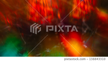 Cracked blur light. Damaged flare. Bright glass red orange green abstract prism beam on black. Optical colorful reflection background. Cracked blur light. Damaged flare. Bright glass red orange green abstract prism beam on black. Optical colorful reflection background. 138843310
