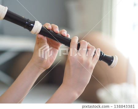 Image of a child playing the recorder 138843381