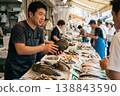 Seafood Market Vendor Holding Large Pen Shell for Sale 138843590