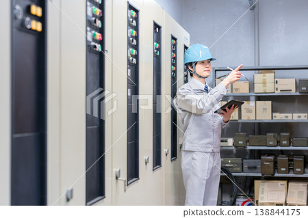 A male worker inspecting equipment. A male worker inspecting equipment. 138844175