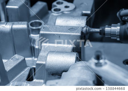 Industrial robotic arm performing precision deburring and chamfering on aluminum casting parts. Industrial robotic arm performing precision deburring and chamfering on aluminum casting parts. 138844668