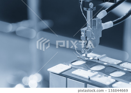 Automated assembly process of an EV battery pack using high-precision robotic systems in a modern smart factory. Automated assembly process of an EV battery pack using high-precision robotic systems in a modern smart factory. 138844669