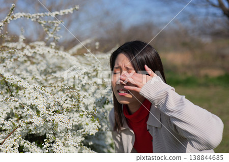 A woman rubbing her eyes due to hay fever. A woman rubbing her eyes due to hay fever. 138844685