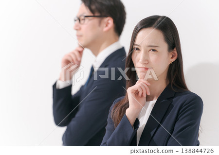 Portraits of men and women in suits as they contemplate Portraits of men and women in suits as they contemplate 138844726