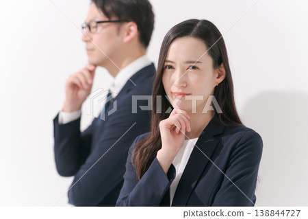 Portraits of men and women in suits as they contemplate Portraits of men and women in suits as they contemplate 138844727
