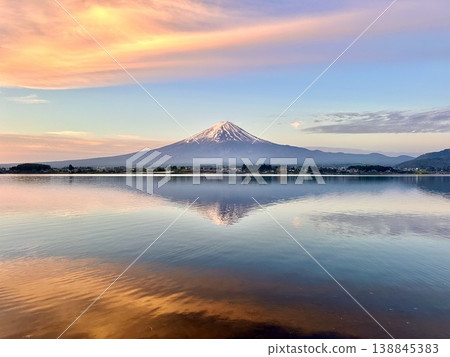 Mount Fuji and clouds bathed in the morning sun, as seen from Lake Kawaguchi. Mount Fuji and clouds bathed in the morning sun, as seen from Lake Kawaguchi. 138845383