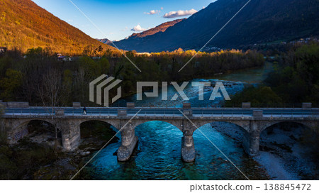 Aerial view of Soca river with its distinctive emerald green colour, nestled between the Julian Alps in western Slovenia. Aerial view of Soca river with its distinctive emerald green colour, nestled between the Julian Alps in western Slovenia. 138845472