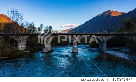 Aerial view of Soca river with its distinctive emerald green colour, nestled between the Julian Alps in western Slovenia. 138845474