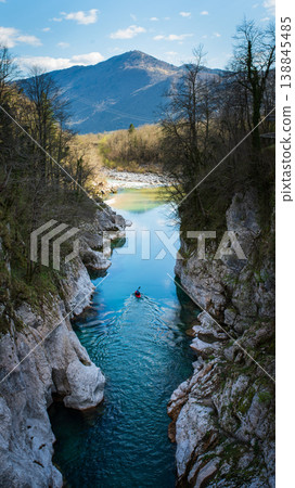 Kayaker paddling in Soca River turquoise canyon in Julian Alps Slovenia. Vertical shot Kayaker paddling in Soca River turquoise canyon in Julian Alps Slovenia. Vertical shot 138845485