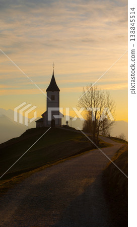 Vertical sunrise view of Jamnik Church in Slovenia with pastel sky and copy space Vertical sunrise view of Jamnik Church in Slovenia with pastel sky and copy space 138845514