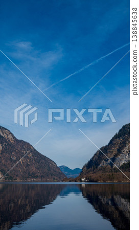 Vertical view of calm mountain, river and town. Vertical view of calm mountain, river and town. 138845638