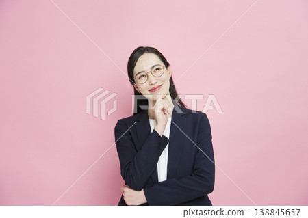 A smiling businesswoman on a pink background. A smiling businesswoman on a pink background. 138845657