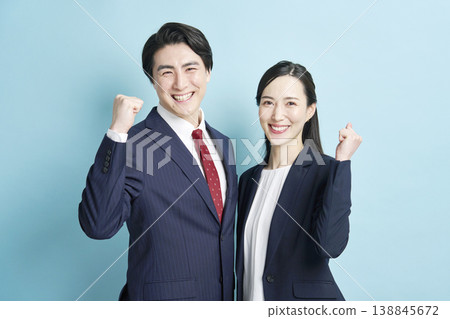 Male and female business people doing guts pose 138845672