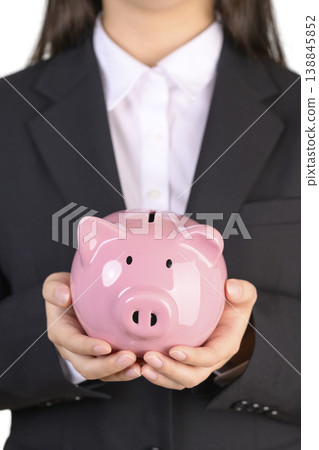 一位穿著西裝的女士拿著存錢罐 138845852