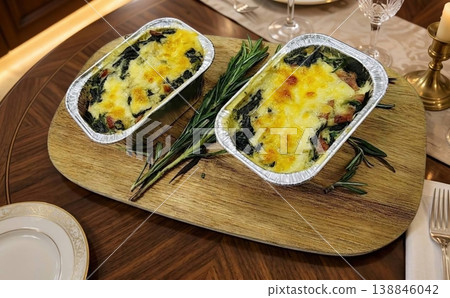 Gourmet Baked Spinach and Cheese Gratin in Foil Trays on Elegant Wooden Platter Gourmet Baked Spinach and Cheese Gratin in Foil Trays on Elegant Wooden Platter 138846042