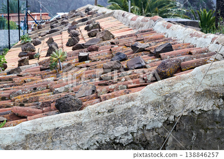Stones Holding Weathered Terracotta Roof Stones Holding Weathered Terracotta Roof 138846257