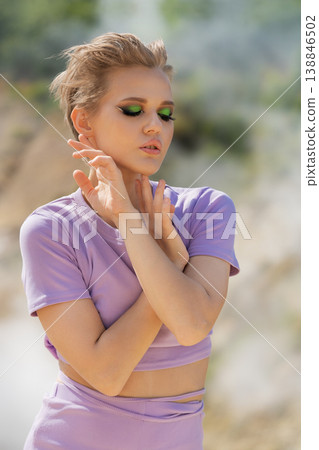 Fashion portrait of a serene woman with pixie hair and vibrant green eyeshadow 138846502