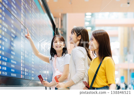 Three women looking at an electronic display board at the airport. (Photo courtesy of Kansai International Airport (KIX)) Three women looking at an electronic display board at the airport. (Photo courtesy of Kansai International Airport (KIX)) 138846521