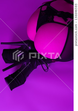 High angle view woman's buttocks in thong, garter belt, stockings, heels. Closeup woman low section High angle view woman's buttocks in thong, garter belt, stockings, heels. Closeup woman low section 138846593