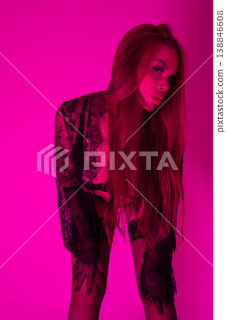 Sensual young woman with long hair wears black lace lingerie looking at camera, mysterious posing Sensual young woman with long hair wears black lace lingerie looking at camera, mysterious posing 138846608