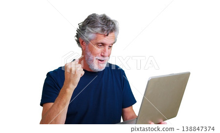 Mature man expressing excitement and victory watching content on a laptop 138847374