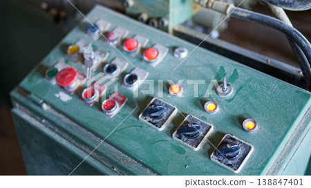 Old industrial machinery control panel with buttons and switches Old industrial machinery control panel with buttons and switches 138847401