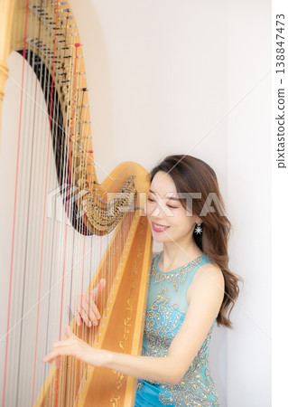 Female harpist Female harpist 138847473