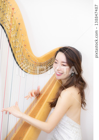 Female harpist Female harpist 138847487