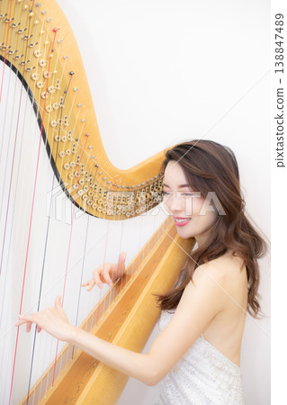 Female harpist Female harpist 138847489