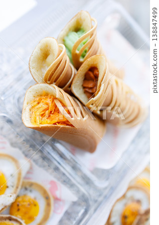 Stack of pancake roll filled with assorted filling. 138847499