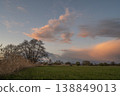 Landscape with clouds and trees under changing sky at end of day 138849013
