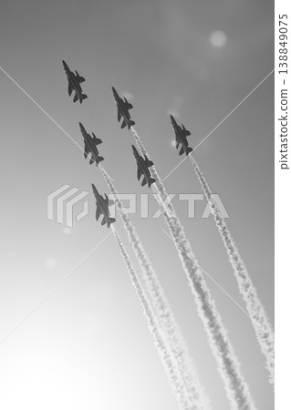 Blue Impulse soaring through the sky with the sun as a backdrop. Blue Impulse soaring through the sky with the sun as a backdrop. 138849075