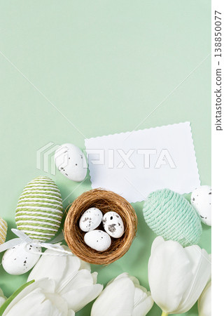 White tulips and Easter eggs on mint background with blank card White tulips and Easter eggs on mint background with blank card 138850077