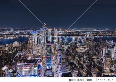 Night aerial view of Hudson Yards district and Manhattan skyline with illuminated modern skyscrapers and city lights in New York City USA 138850307