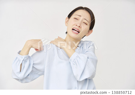 Woman in her 40s with stiff shoulders, white background 138850712