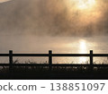 A tranquil scene of a lake shimmering golden in the light of the morning glow. 138851097