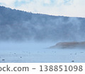 A mystical and tranquil morning scene unfolds over Lake Yamanaka, shrouded in morning mist. 138851098