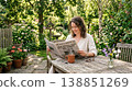 A woman quietly reading a book in a peaceful setting. 138851269
