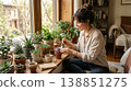 A woman carefully tending to her indoor plants. 138851275