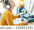 A woman relaxing while listening to her favorite records. 138851281