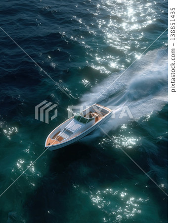 Luxury speedboat cutting through sparkling blue ocean water, leaving a white wake, symbolizing freedom, power, and high end summer recreation 138851435