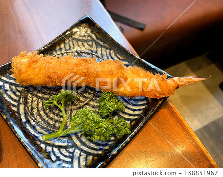 Shrimp Fry (single serving) - Large, plump shrimp fries served on a square plate. Shrimp Fry (single serving) - Large, plump shrimp fries served on a square plate. 138851967