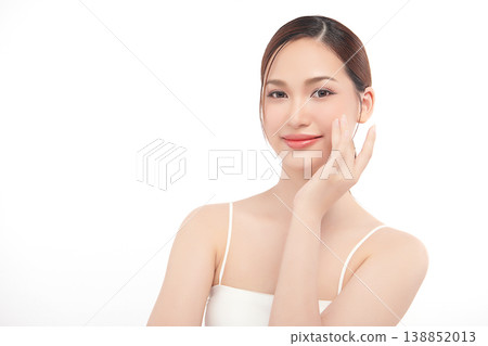 A beautiful young Asian woman with clean, fresh skin against a white background. Skincare, facial treatment, cosmetology, beauty, and spa. An elegant portrait of an Asian woman. 138852013