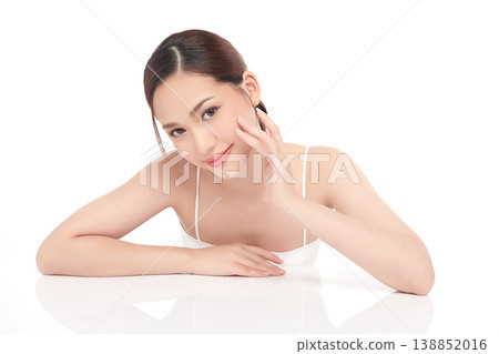 A beautiful young Asian woman with clean, fresh skin against a white background. Skincare, facial treatment, cosmetology, beauty, and spa. An elegant portrait of an Asian woman. A beautiful young Asian woman with clean, fresh skin against a white background. Skincare, facial treatment, cosmetology, beauty, and spa. An elegant portrait of an Asian woman. 138852016