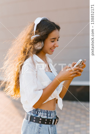 Joyful Teen Girl Messaging On Smartphone 138852171