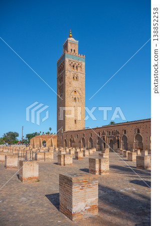 The Kutubiyya Mosque stands tall in Marrakesh, Morocco. People gather around as they admire the structure and the surrounding area during sunny weather. The Kutubiyya Mosque stands tall in Marrakesh, Morocco. People gather around as they admire the structure and the surrounding area during sunny weather. 138852258