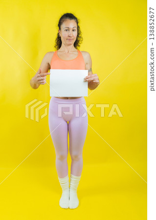 Woman holding blank sign pointing offering message space Woman holding blank sign pointing offering message space 138852677