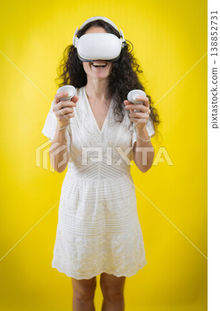 Smiling woman enjoying immersive virtual reality experience 138852731