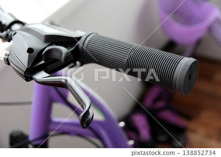 Detailed close-up of a bicycle handlebar with brake lever and textured grip, highlighting modern design, control, and urban cycling lifestyle. Detailed close-up of a bicycle handlebar with brake lever and textured grip, highlighting modern design, control, and urban cycling lifestyle. 138852734