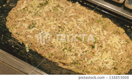 The finished cheese monjayaki, a dish on a hot plate. 138853008